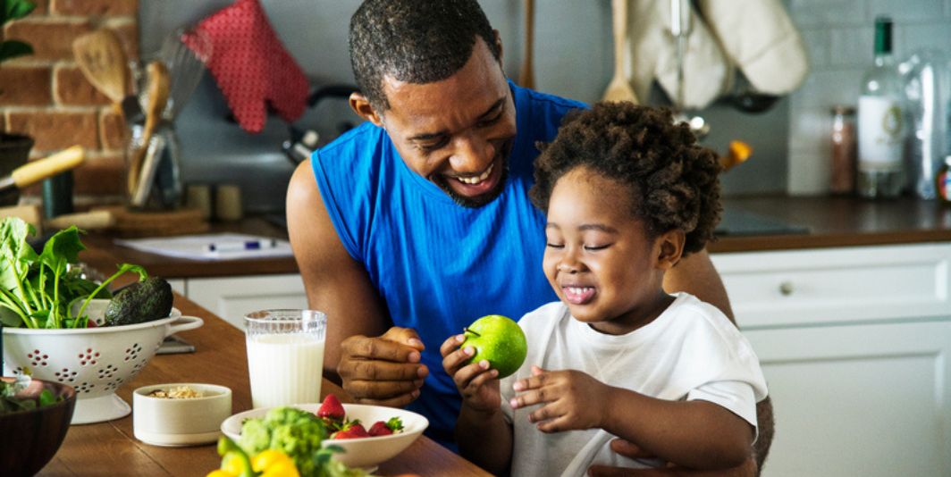 Father and Daughter with bowl of fruit 